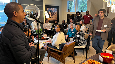 Abiel Woldu, a second-year student and president of the Black Law Student Association (BLSA), addresses fellow BLSA members and others during a recent brunch at Dean Varona’s home.