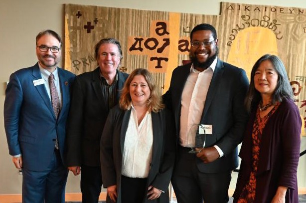 Miguel Willis poses with professors in Sullivan Hall