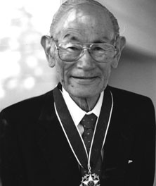A black and white profile picture of Fred Korematsu