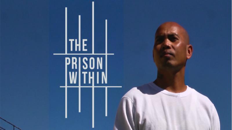 A man standing in front of a watchtower outside of a prison - banner image from theprisonwithin.org