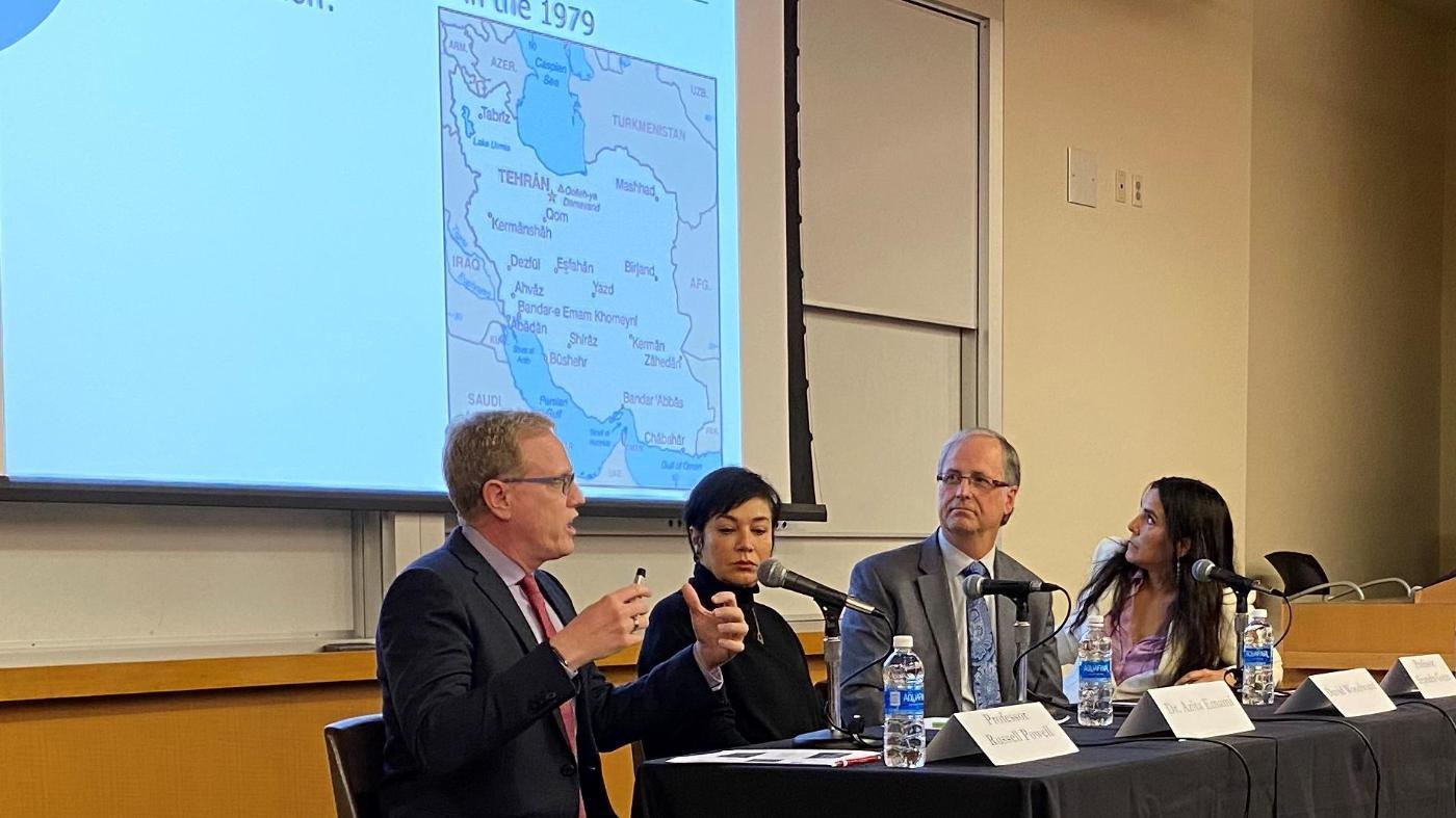 Professor Russell Powell describes the creation of Iran's constitution while three other panelists listen.