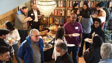 Guests socializing at Dean Varona's community brunch