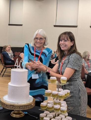 At a 40th anniversary reception organized by Seattle U Law, a conference diamond sponsor, Professor Laurel Oates cuts a cake with LWI immediate past president Susie Salem