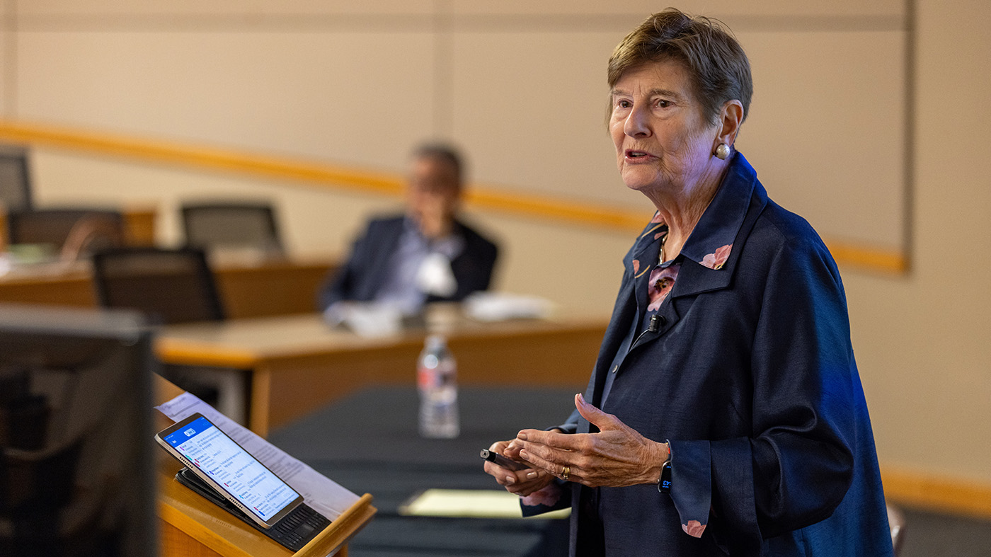 A woman giving a speech at a podium